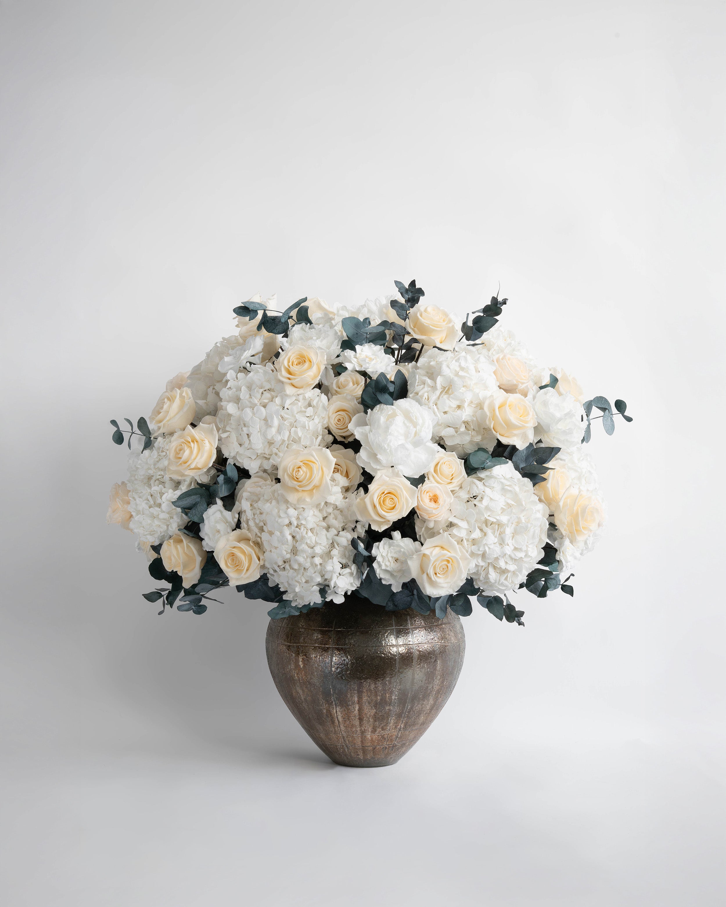 Preserved white hydrangea, peony and rose flower arrangement 