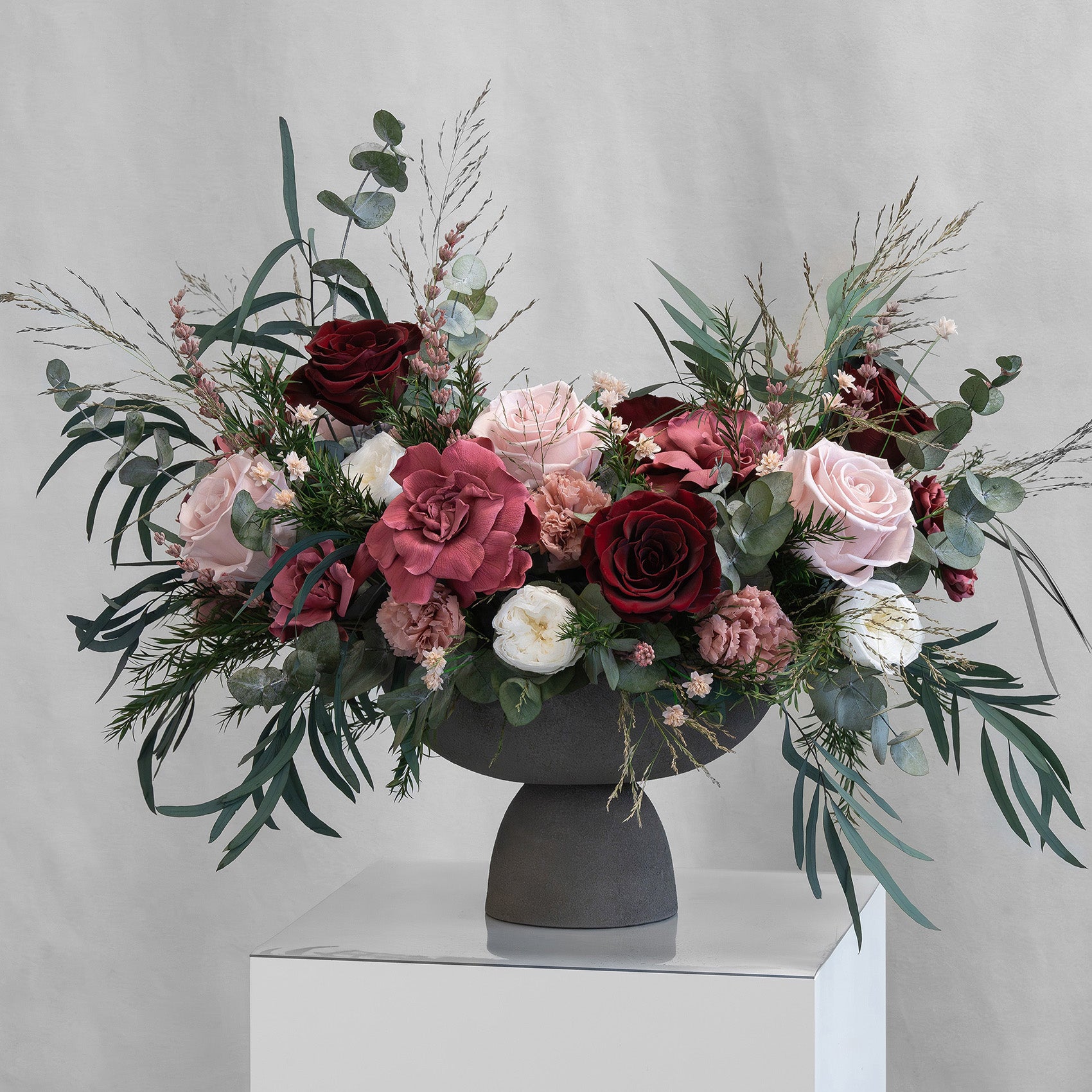 PRESERVED BURGUNDY & CHERRY MIXED FLOWER ARRANGEMENT IN GREY FOOTED VASE FOR YACHTS