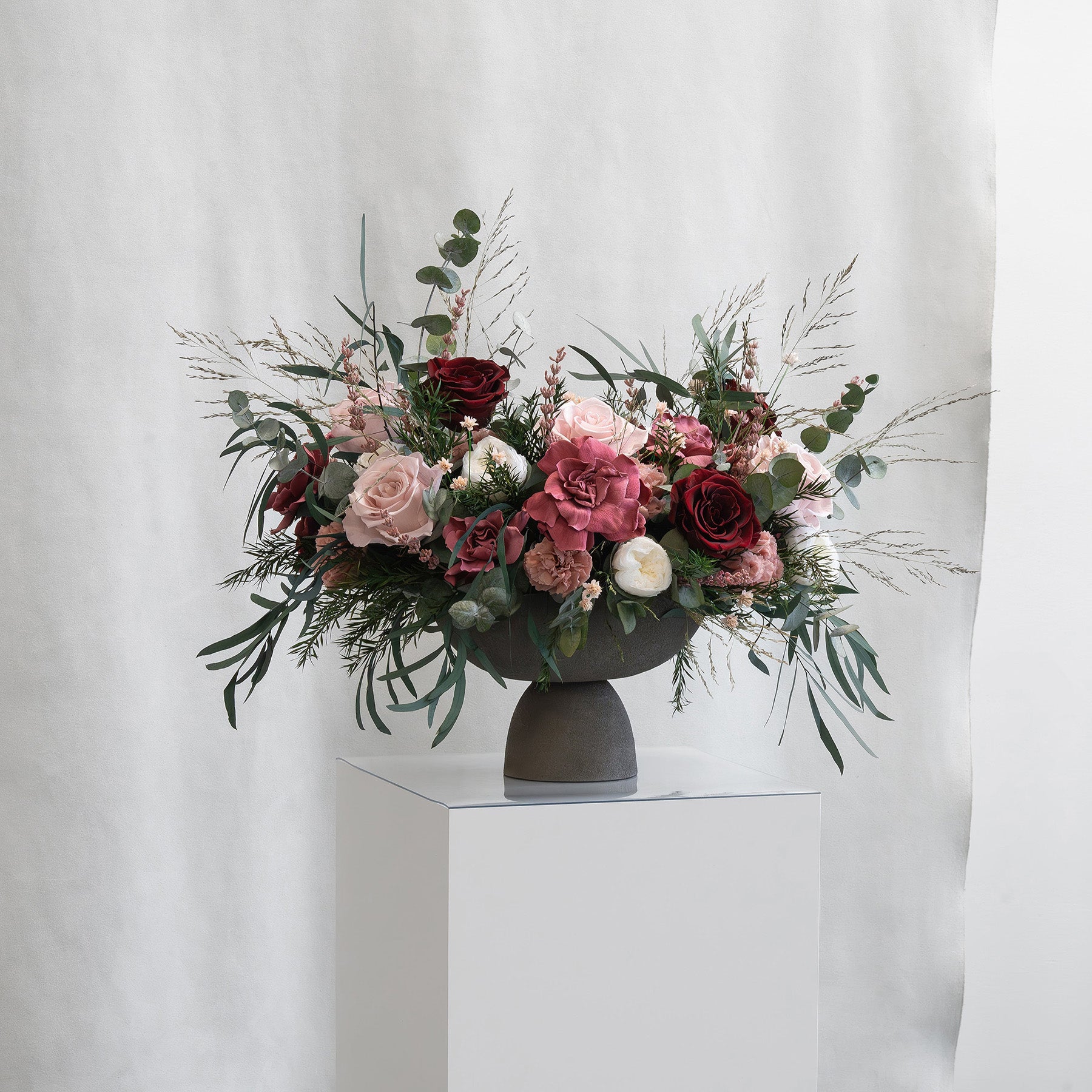 PRESERVED BURGUNDY & CHERRY MIXED FLOWER ARRANGEMENT IN GREY FOOTED VASE FOR YACHTS