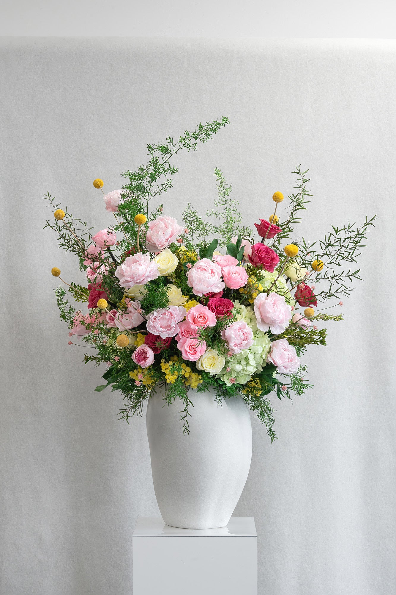 Preserved green, yellow and pink mixed flower arrangement 