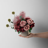 Preserved burgundy hydrangea flower arrangement in stone vase 
