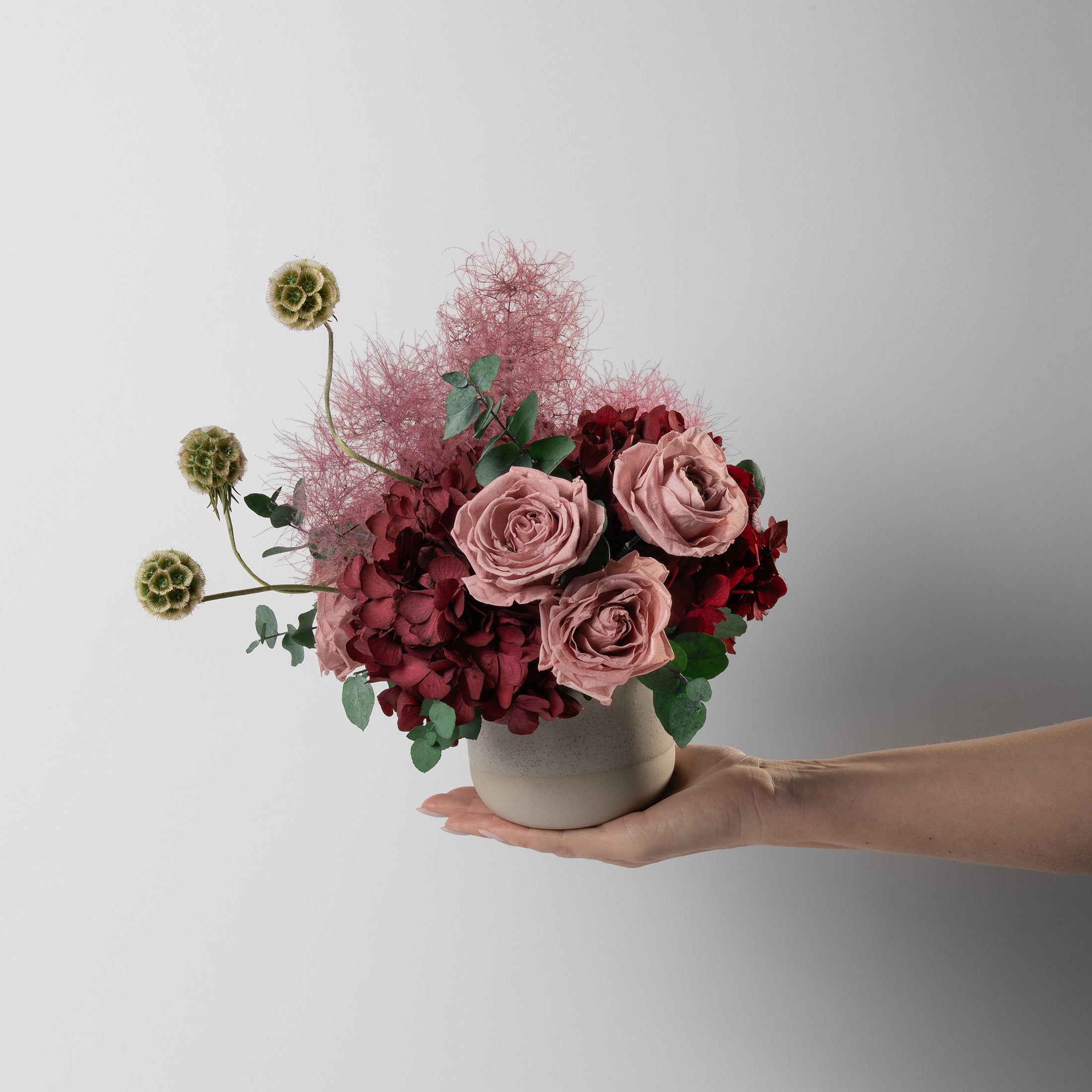 Preserved burgundy hydrangea flower arrangement in stone vase 