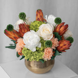Preserved green, peach and orange flower arrangement for yachts
