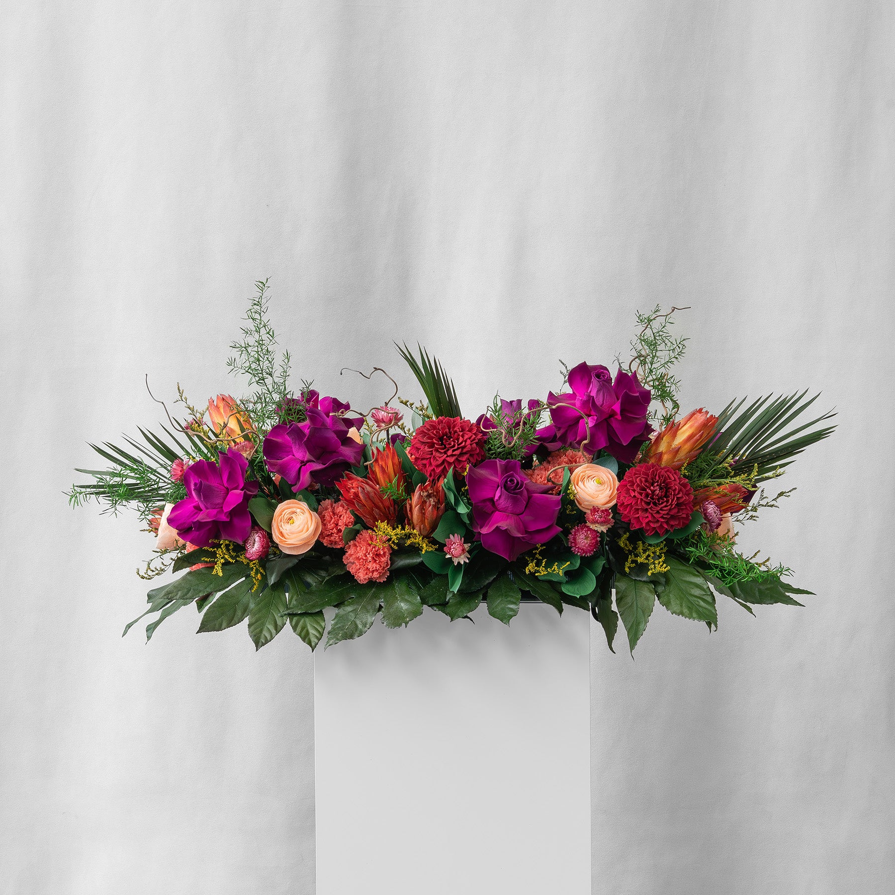 Preserved purple, green and red tropical long low tray flower arrangement for yachts 