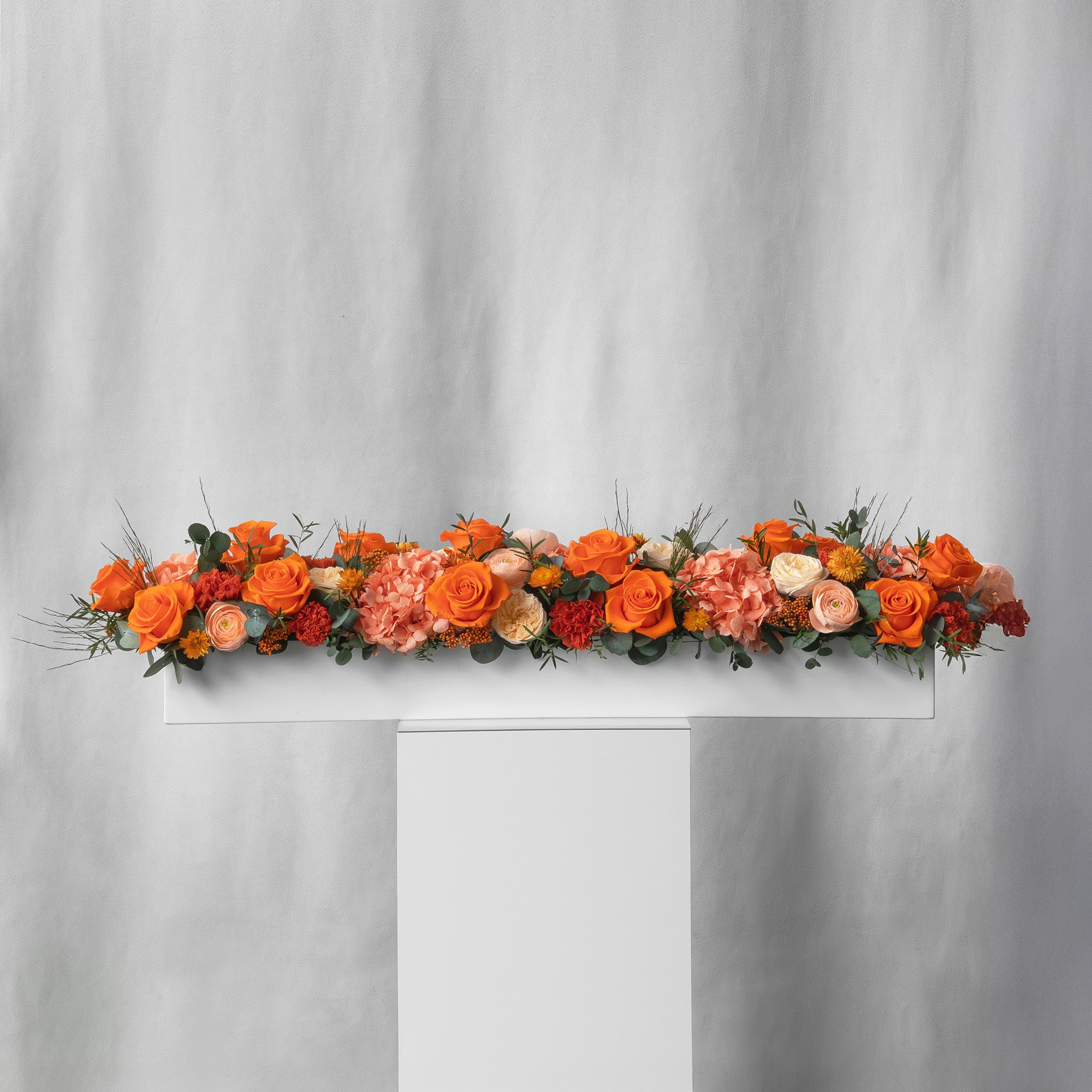 Preserved orange long low flower arrangement for yachts 