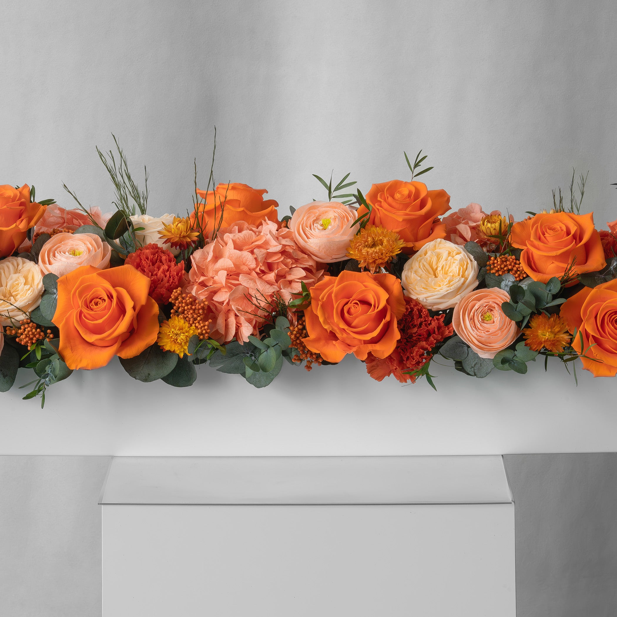 Preserved orange long low flower arrangement for yachts 