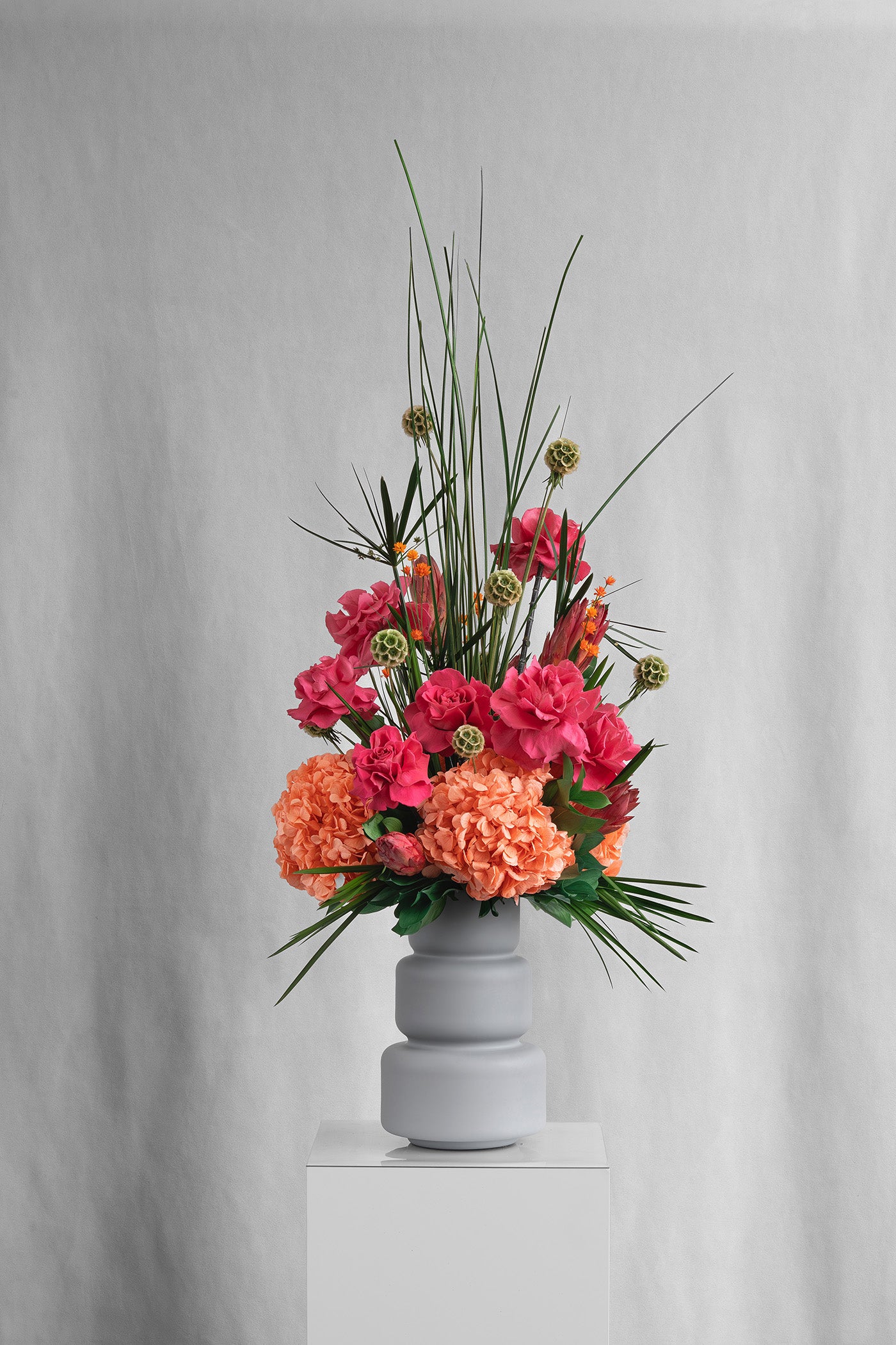 Preserved orange and pink tropical flower arrangement