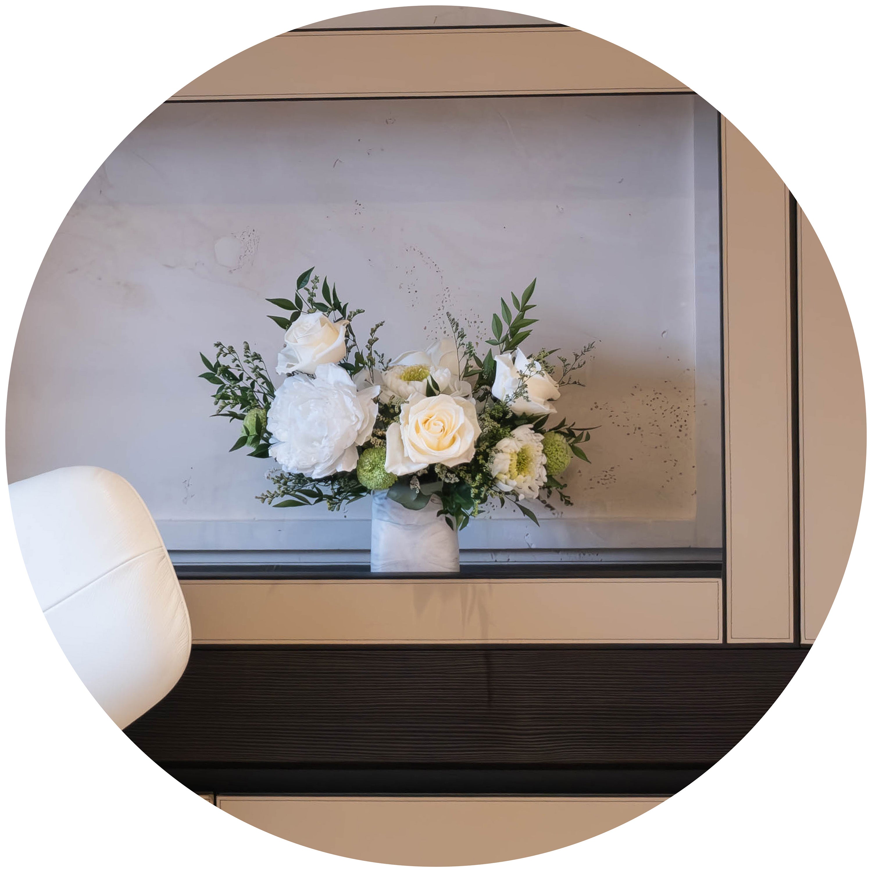 Preserved mixed flower arrangement with eucalyptus on shelf