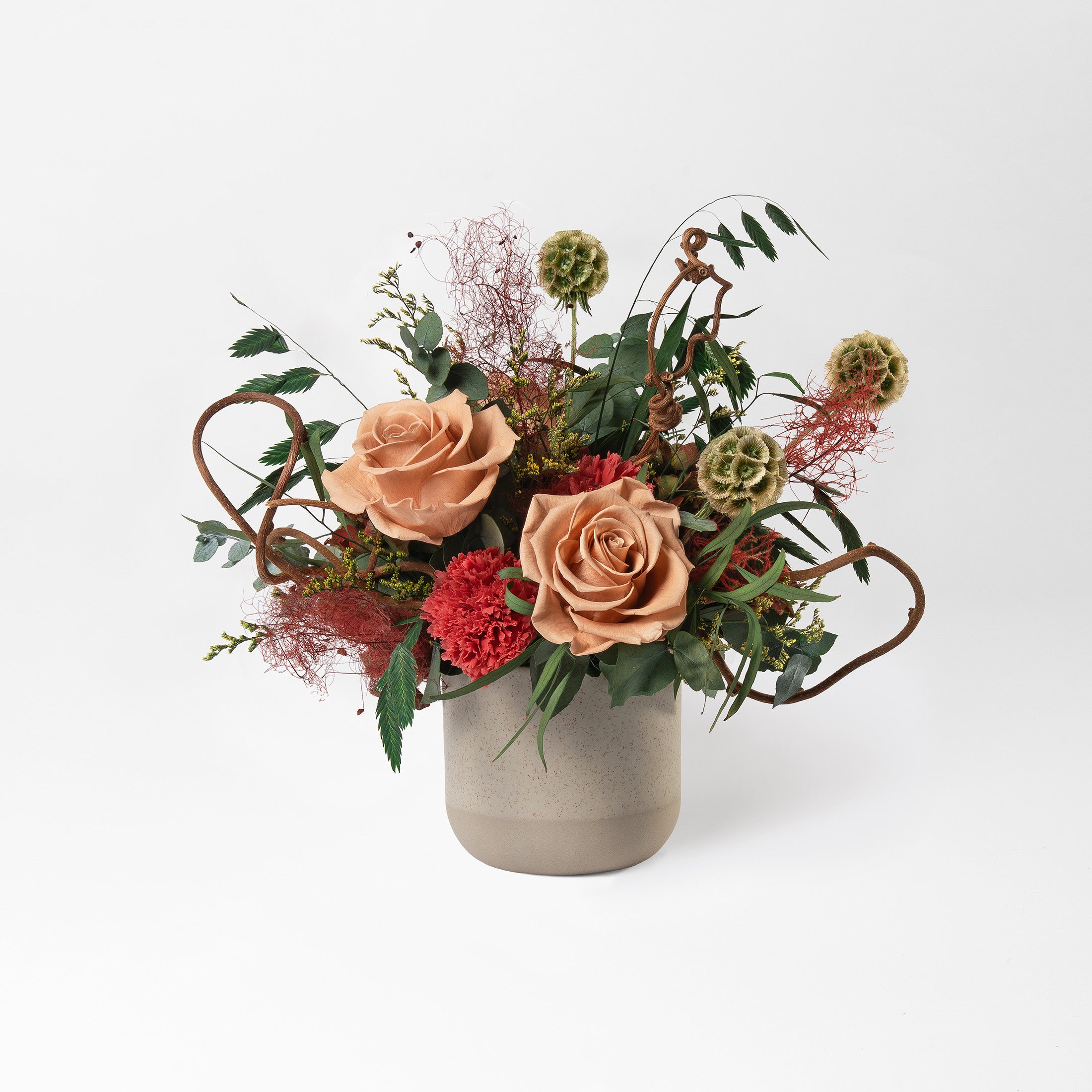 Preserved green and toffee floral arrangement in a ceramic vase for yachts interior. 