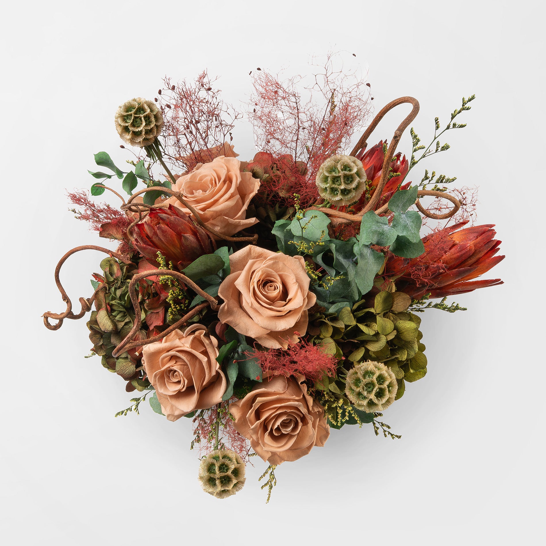 Bouquet of toffee and green mix preserved flowers in a ceramic vase for yachts