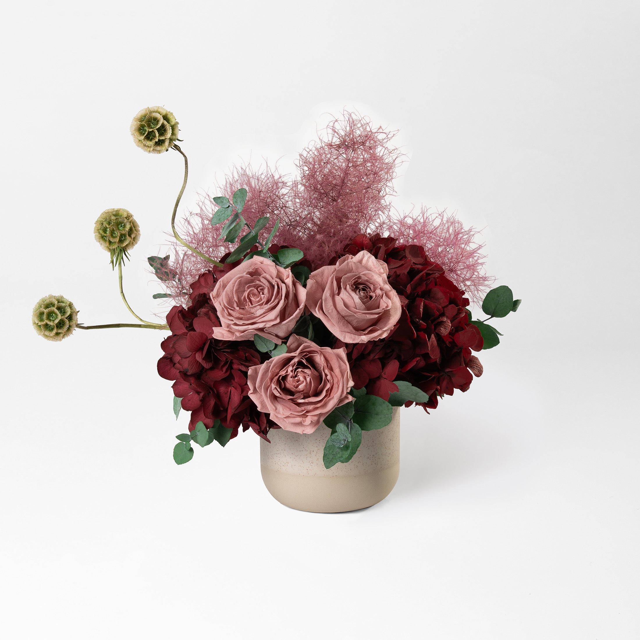 Preserved burgundy hydrangea flower arrangement in stone vase 