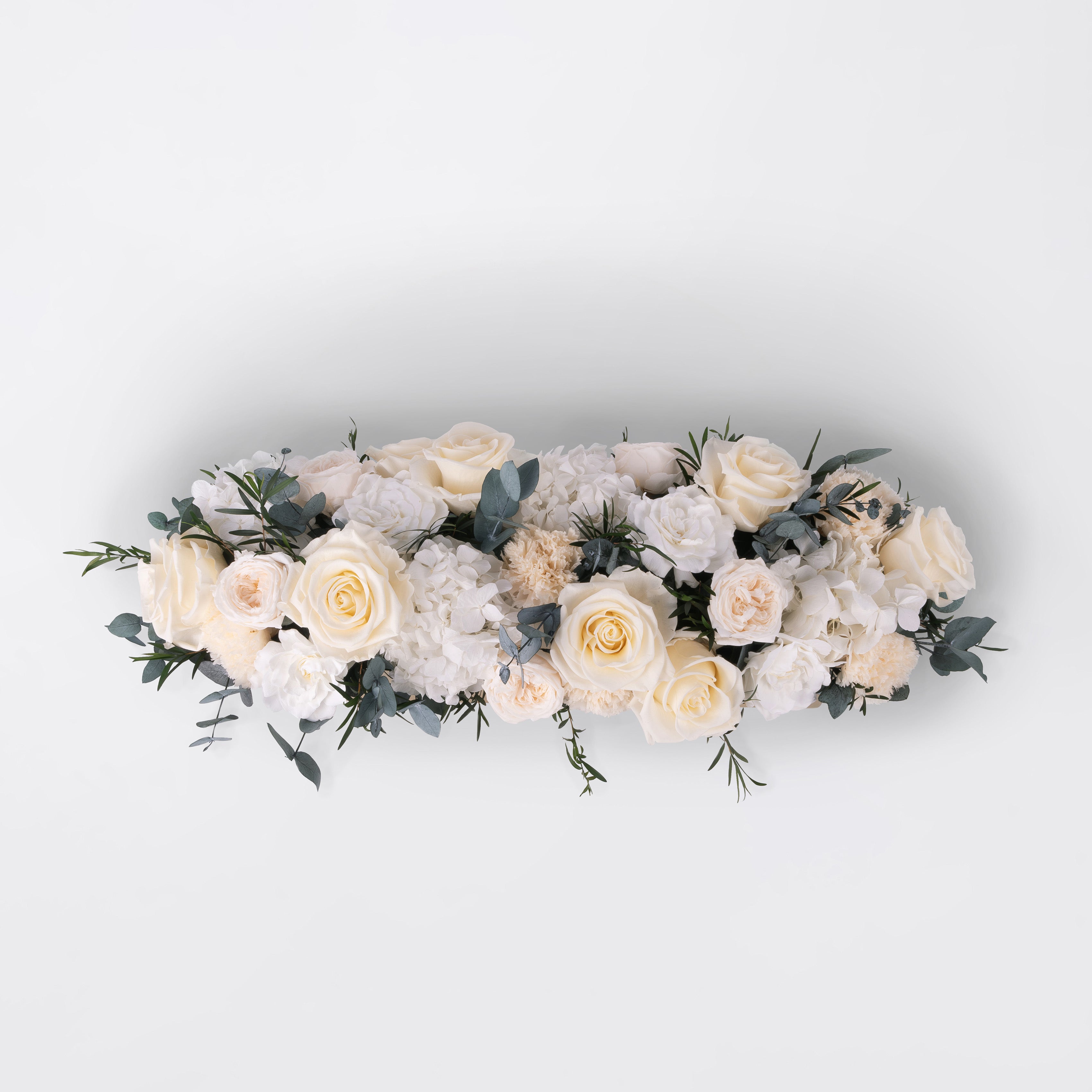 Preserved white and peach long low flower arrangement for yachts 